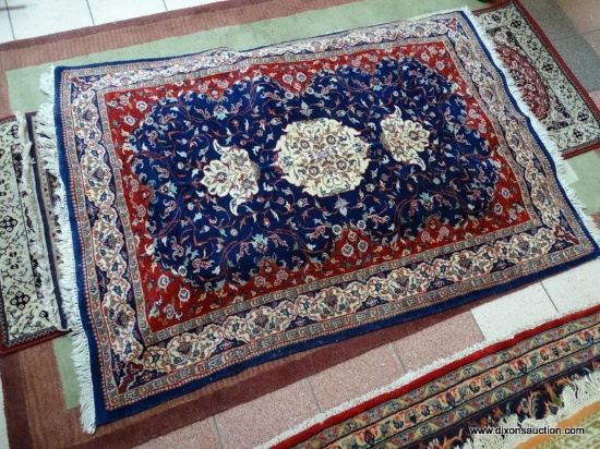 HANDMADE PERSIAN IN BLUE, RED, AND IVORY. MEASURES APPROXIMATELY 4 FT 1 IN X 6 FT 2 IN. ITEM IS SOLD