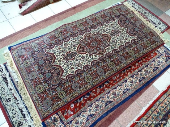 MACHINE MADE TABRIS IN MAROON, BLUE, AND IVORY. MEASURES APPROXIMATELY 3 FT X 6 FT 5 IN. ITEM IS