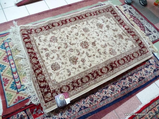 MACHINE MADE ORIENTAL STYLE RUG IN MAROON, IVORY, AND BROWN. MEASURES APPROXIMATELY 3 FT 3 IN X 5