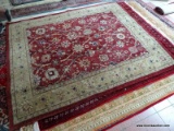 MACHINE MADE ORIENTAL STYLE AREA RUG IN MAROON, IVORY, AND GREEN. MEASURES APPROXIMATELY 7 FT 10 IN