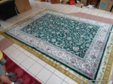 HANDMADE ORIENTAL BOKHARA IN GREEN, IVORY, AND MAUVE. MEASURES APPROXIMATELY 8 FT 11 IN X 12 FT.