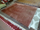 ESTATE OWNED MACHINE MADE MAUVE ORIENTAL SCULPTED RUG. MEASURES APPROXIMATELY 7 FT 11 IN X 10 FT 6