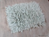 MINT GREEN AREA RUG. MEASURES APPROXIMATELY 2 FT 1 IN X 2 FT 9 IN. ITEM IS SOLD AS IS WHERE IS WITH