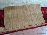 BRAIDED LEATHER RUG. MEASURES APPROXIMATELY 2 FT 6 IN X 4 FT 3 IN. ITEM IS SOLD AS IS WHERE IS WITH