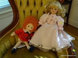 (LR) PORCELAIN DOLL IN PINK- 17 IN H AND AN ANNIE DOLL- 15 IN H, ITEM IS SOLD AS IS WHERE IS WITH NO