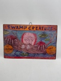 (5E) SWAMP CREATURE DISTRESSED-LOOK METAL SIGN HALLOWEEN DECORATION (17 X 11 INCHES)