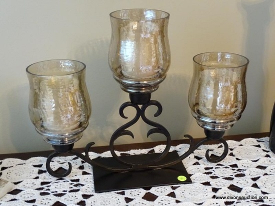 (FR) BLACK METAL DECORATIVE CANDELABRA WITH (3) AMBER COLORED GLASS SHADES & PIER 1 CANDLES.