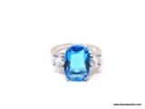 .925 STERLING SILVER LADIES 4 CT BLUE TOPAZ RING. SIZE 8. ITEM IS SOLD AS IS WHERE IS WITH NO