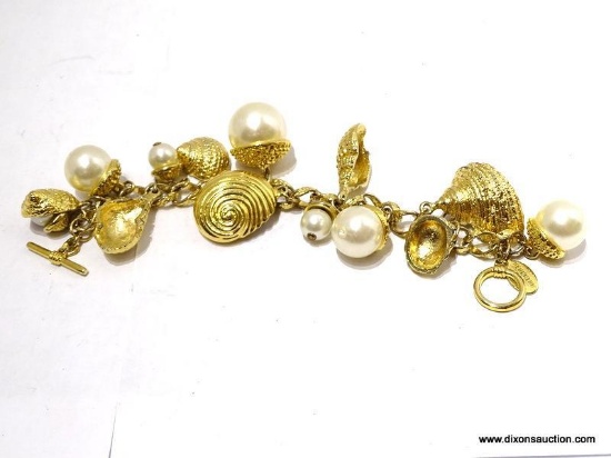 (SC) GEORGIOUFAUX PEARL WITH GOLD TONE SEA SHELL'SMEASURE 8 IN. ITEM IS SOLD AS IS, WHERE IS, WITH