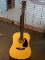 (SC) SQUIER BY FENDER ACOUSTIC GUITAR. MODEL 093-0300-021. SERIAL #0060100523. INCLUDES A STRAP. AND