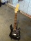 (SC) FENDER STRATOCASTER BLACK ELECTRIC GUITAR WITH PEARL FINISH PICKGUARD. HAS A LOCKING NUT NECK.