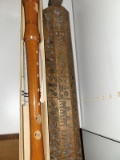 (BAY 7) 2 PIECE LOT TO INCLUDE A WOODEN FLUTE AND A WOODEN CARVED WALL DECORATION. ITEM IS SOLD AS