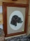FRAMED PRINT OF A BLACK LAB WITH A DUCK. FRAMED IN A WOODEN FRAME. ITEM IS SOLD AS IS WHERE IS WITH