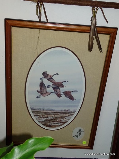 FRAMED PRINT OF CANADIAN GEESE IN FLIGHT. IS DOUBLE MATTED AND FRAMED IN A WOODEN FRAME. MEASURES 18