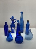 (9I) VINTAGE COBALT BLUE GLASS BOUDOIR AND COSMETIC BOTTLES, MOSTLY DECORATIVE. TALLES IS 11 INCHES