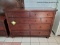 (R1) ASPENHOME CAMBRIDGE CHESSER IN BROWN CHERRY FINISH. RETAILS FOR $930 ONLINE! MEASURES 58 IN X