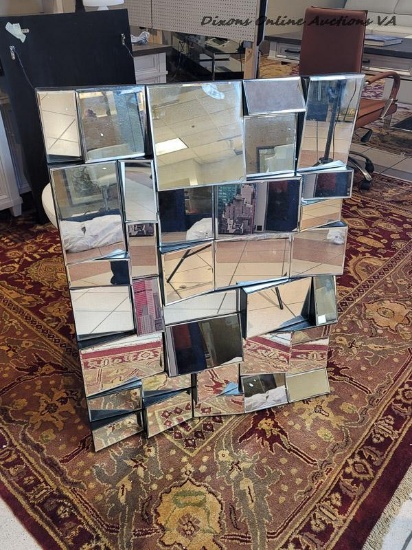 (LR) THE AXIS MIRROR WILL ADD REFLECTIVE PIZZAZZ TO YOUR HOME. THE INTERWOVEN DESIGN OF GLASS WILL