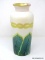 An opaque white bodied vase. The interior of the neck is iridescent gold cased with a gold rim. The