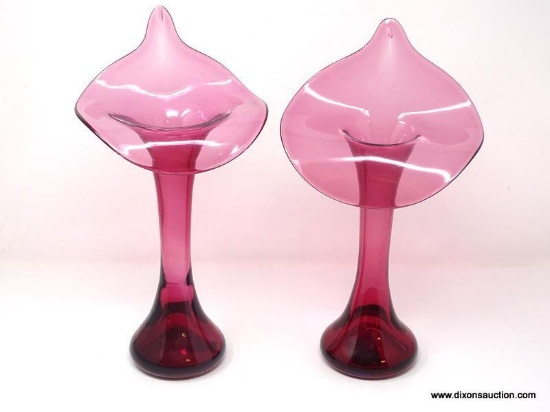 A pair of translucent cranberry glass Jack-in-the-Pulpit shaped vases. No signature found.