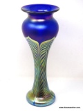 A cobalt blue iridescent finished vase having a wide mouth tapering at the neck and forming a