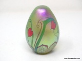 An egg shaped, translucent, gold/green surface decorated hearts & vines design with a beautifully