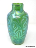 A green translucent vase with King Tut styled swirls. The rim has no lip. The shoulders flare to a