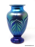 Cobalt blue iridescent urn vase with pulled and feathered design. Surface decorated with a darker