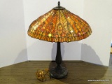Slagged Glass Lamp With Bronze Toned Base And Orange, Red, And Yellow Shade. Measures 21 In X 26 In.