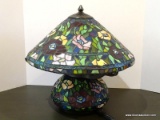Slagged Glass Floral Themed Lamp With Slagged Glass Base. Primary Colors Include Green, Red, And