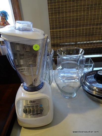 OSTER BLENDER WITH 8 ASSORTED GLASS FLOWER VASES. ITEM IS SOLD AS IS WHERE IS WITH NO GUARANTEES OR