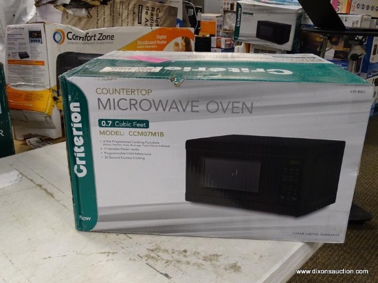 (R1P2) CRITERION 0.7 CU.FT. BLACK COUNTERTOP MICROWAVE. RETAILS FOR $70 ONLINE. CONDITION REPORT: