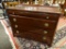 (R2) MAHOGANY 4 DRAWER CHEST WITH BRASS PULLS. MEASURES 46 IN X 20 IN X 36 IN. ITEM IS SOLD AS IS