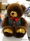 (R2) LARGE STUFFED TEDDY BEAR IN A PLAID VEST. MEASURES APPROXIMATELY 19 IN TALL. ITEM IS SOLD AS IS