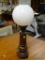 (R2) PINE LAMP WITH BRASS ACCENTS. MEASURES 18 IN TALL. HAS A GLASS SHADE. ITEM IS SOLD AS IS WHERE