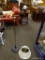 (R2) BRASS FLOOR LAMP WITH ADJUSTABLE ARM. MEASURES 51 IN TALL. INCLUDES A SHADE. ITEM IS SOLD AS IS
