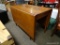 (R2) MAHOGANY DROP-SIDE TABLE. WITH SIDES DOWN MEASURES 24 IN X 42 IN X 30 IN. ITEM IS SOLD AS IS