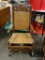 (R2) MAHOGANY SPRING ROCKER WITH WOVEN BOTTOM AND BACK. MEASURES 22 IN X 20 IN X 38 IN. ITEM IS SOLD
