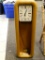 (R3) HOWARD MILLER EIGHT DAY WIND PENDULUM WALL CLOCK WITH PENDULUM AND OAK CASE. MEASURES 11 IN X
