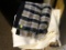 (R3) LOT OF 2 THROW BLANKETS. 1 IS PLAID AND 1 IS WHITE. ITEM IS SOLD AS IS WHERE IS WITH NO