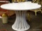 (R3) WHITE DINETTE TABLE WITH CONE SHAPED BASE. MEASURES 48 IN X 29 IN. ITEM IS SOLD AS IS WHERE IS