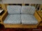 (R3) WICKER LOVESEAT WITH BLUE FLORAL UPHOLSTERED CUSHIONS. MEASURES 53 IN X 29 IN X 30 IN. ITEM IS