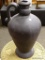 (R3) LARGE BROWN SINGLE HANDLE JUG. MEASURES 21 IN TALL. ITEM IS SOLD AS IS WHERE IS WITH NO