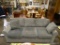 (R3) GRAY UPHOLSTERED SOFA WITH ACCENT PILLOWS. MEASURES 83 IN X 38 IN X 34 IN. ITEM IS SOLD AS IS