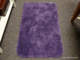 (R2) PURPLE SHAGGY BATHTUB MAT. ITEM IS SOLD AS IS WHERE IS WITH NO GUARANTEE OR WARRANTY. NO