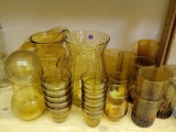 LOT OF VINTAGE AND MODERN AMBER COLORED GLASSWARE INCLUDING ANCHOR HOCKING RAINFLOWER PITCHER, 8