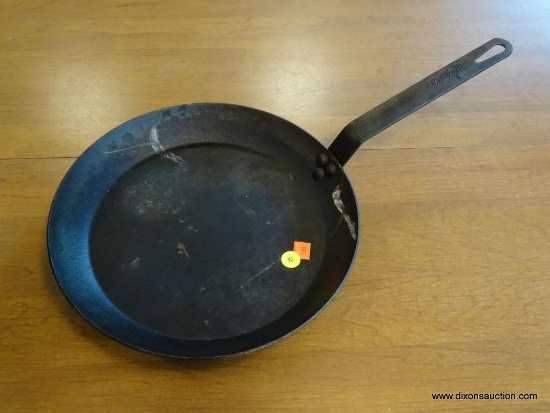 CENTER ROW FRONT - LODGE BRAND CAST IRON SKILLET APPROX 12 INCHES. ITEM IS SOLD AS IS WHERE IS WITH