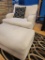 OVERSIZED CREAM COLOR CHAIR AND OTTOMAN WITH SINGLE BLACK AND CREAM PILLOW. MEASURES APPROX. 43
