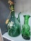 GREEN GLASS VASE IS IN THE SHAPE OF A VIOLIN AND A GREEN GLASS JUG. VERY CUTE. IS SOLD AS IS WHERE