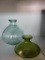 2 FLOWER VASES. ONE IS GREEN AND THE OTHER IS CLEAR. CLEAR VASE MEASURES APPROX. 8IN. IS SOLD AS IS