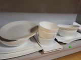 SHELF LOT. CREAM COLOR DISH SET TO INCLUDE VARIOUS BOWLS AND PLATES. VARUOIS BRANDS AND MATERIALS.